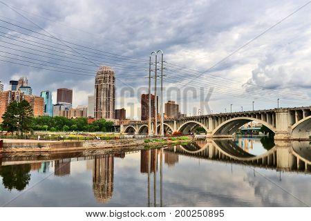 Minneapolis downtown skyline and Third Avenue Bridge above Mississippi river. Midwest USA Minnesota state.