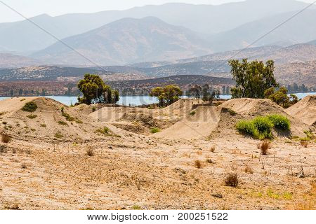 CHULA VISTA, CALIFORNIA - JUNE 30, 2017:  BMX dirt moguls with a view of Otay Lake at the Chula Vista Elite Athlete Training Center, built in 1995 for the training of Olympic athletes.