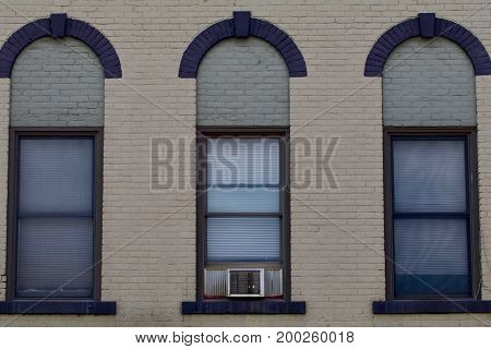 Three windows from a nineteenth century brick building