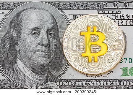 Golden Bitcoins on US dollars. Electronic money exchange concept, High resolution photo.
