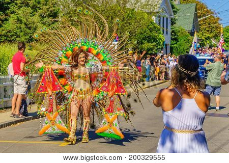Provincetown Massachusetts US August 17 2017 People walking in the 39th Annual Provincetown Carnival Gods and Goddess Parade on Commercial Street