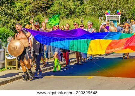 Provincetown Massachusetts US August 17 2017 People walking in the 39th Annual Provincetown Carnival Gods and Goddess Parade on Commercial Street