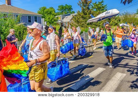 Provincetown Massachusetts US August 17 2017 People walking in the 39th Annual Provincetown Carnival Gods and Goddess Parade on Commercial Street