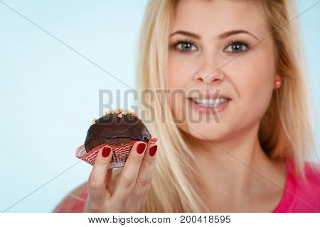 Woman Holding Chocolate Cupcake About To Bite