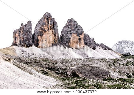 The three peaks of Lavaredo ( Italian: Tre Cime di Lavaredo) in the italian Dolomites isolated by a white cloudy sky