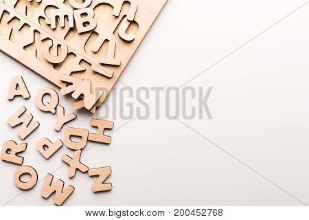Wooden board with English alphabet letters. Sorter toy for child development and education.