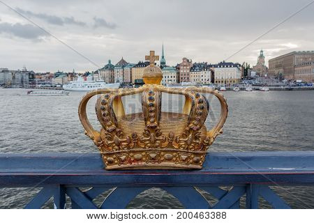 Golden Crown On Skeppsholm Bridge With Stockholms Slot (royal Palace) In The Background - Stockholm