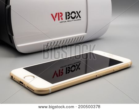 Chiang Rai Thailand: August 9 2017 - Packshot image of Apple iPhone and virtual reality headset (VR Box) on gray background