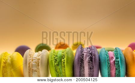 Colorful Macaron sweet and delicious on cream color background with copy space.