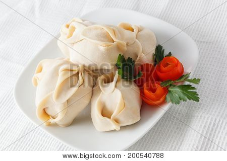 Frozen Dumplings On The White Plate With Green