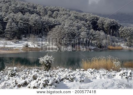 Lake in the mountains in winter on a sunny day (Greece, mountainous Corinthia)