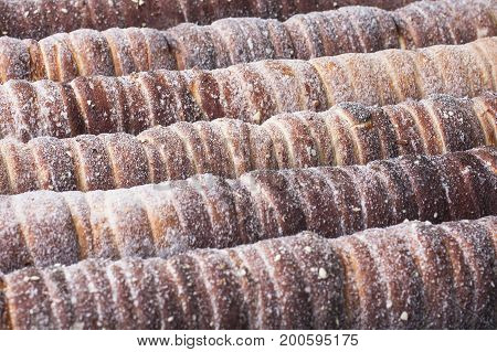 Trdelnik background in process of cooking. Sweet bakery. Prague, Czech Republic cousine