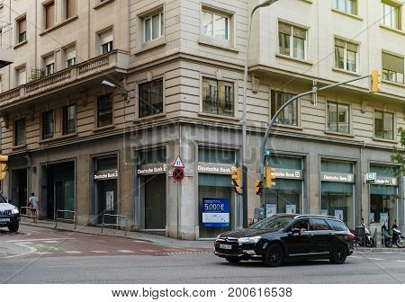 BARCELONA SPAIN - JUN 29 2016: Deutsche Bank branch on Barcelona street with pedestrians and cars in front of it. German bank global banking and financial services company with its headquarters in the Deutsche Bank Twin Towers in Frankfurt.