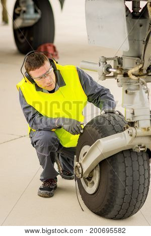 airport worker mechanic service maintenance chassis tire