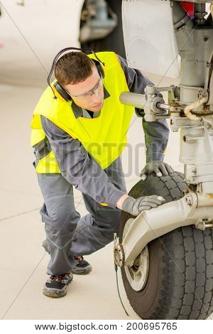 airport worker mechanic service maintenance chassis tire