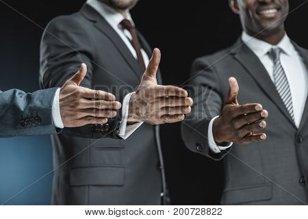 Multiethnic Businessmen Outstretching Hands