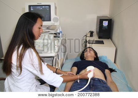 VINNITSA, UKRAINE, JULY 27, 2017: Ultrasonic examination of internal organs in a young girl.