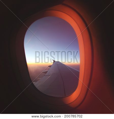 View From Airplane Window at Beautiful Sunrise. Luxery Travel Plane Concept Image.