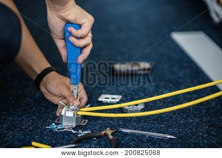Worker Connect A Network Cable With Rj45 Sockets By Punch-down Tool, Process Of Laying The Local Net