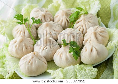 Frozen Dumplings On The White Plate With Green