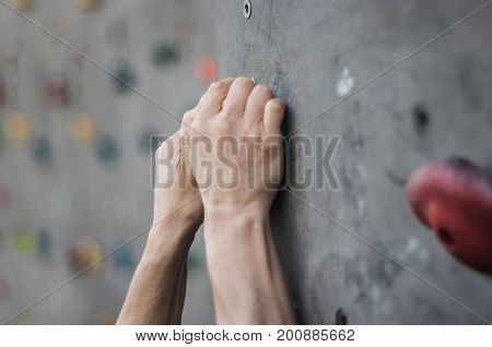 Close-up of asian male Climbing focus on hands