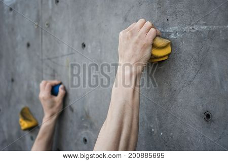 Close-up of asian male Climbing focus on hands