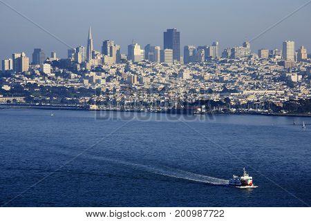 San Francisco downtown city view from Golden Gate Bridge, with clear and blue sea and a running boat