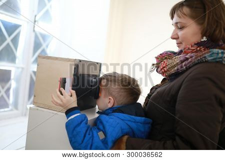 Family Watching Slides In Stereoscope In Laboratory