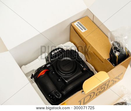 Paris, France - Feb 28, 2017: View From Above Of Cardboard Unboxing With New Professional Nikon D3x 