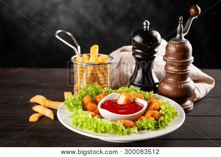 Crispy chicken nuggets on dark background