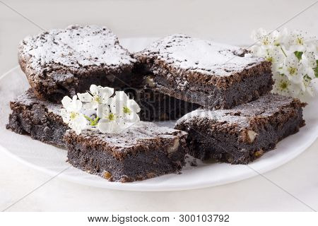 Delicious Chocolate Cake On A White Plate On A White Table. Homemade Pastries. Traditional American 