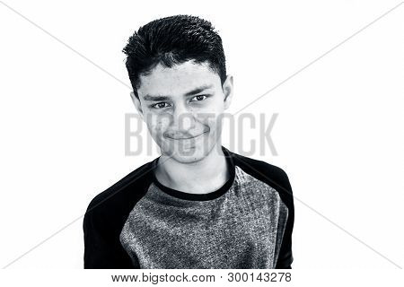 Portrait Shot Of Young Beardless Teenager Isolated On White Expressing Happiness By Smiling Wearing