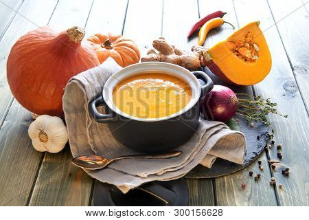 Spicy Pumpkin Creme Soup, Seasoned With With Ginger, Onion, Garlic And Chili Pepper, Is Standing In 