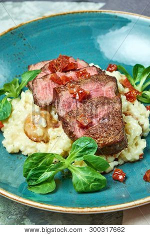 White Rice With Beef. Rizzotto. Gray Light Textured Background. Beautiful Serving Of Dishes