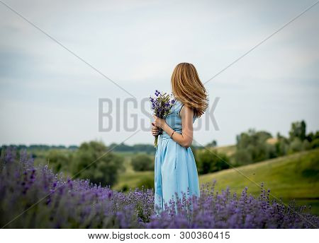 With A Bouquet Of Wild Flowers In Lavender