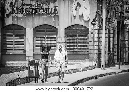 Young Black African-american Millennial Tourists Walking By Margaritaville Montego Bay