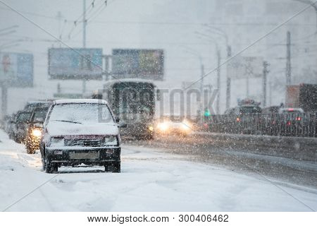 View Of The Street And Parked Cars During A Snowfall/ Heavy Snow Outside The City/ Extreme Snowstorm