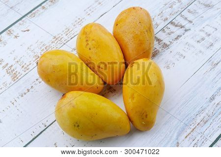 Top View Of Chok Anan Or Chocanon Mango On Wooden Background.