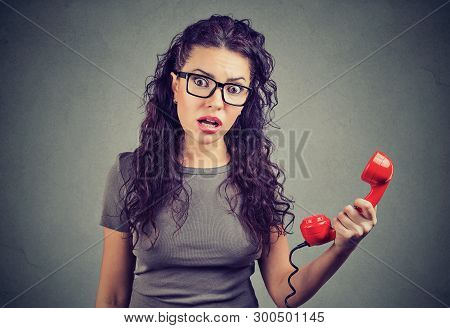 Resentful Shocked Young Woman Looking In Disbelief Holding Telephone Handset