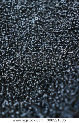 Many Small Black Metal Screws. Construction And Repair. Fixation. Fasteners In The Form Of A Threade