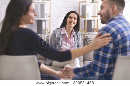 Peace In Family. Smiling Psychologist Looking At Lovely Couple After Effective And Successful Marita