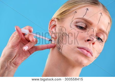 Face Of A Girl With Smooth Skin Without Wrinkles Makes Beauty Shots. Syringe Next To The Face, Skin 