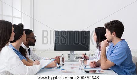 Video Conference. Team Of Doctors Having Meeting, Looking At Blank Screen In Hospital