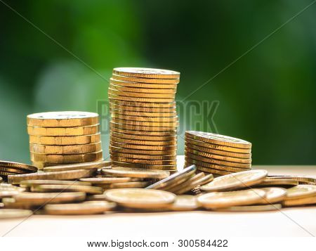 Golden Coins Stack On Wood Table. Concept For Loan, Property Ladder, Financial, Mortgage, Real Estat