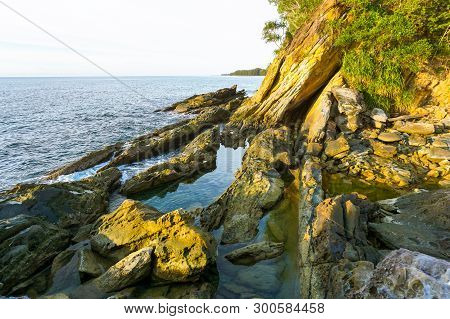 Rocky Sea Shore And Blue Water On Sunny Day. Seascape,south China Sea Coastline, Seaside & Stones In