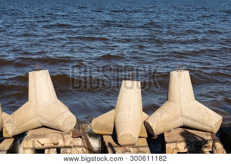 Close View Of Tetrapod Stones On The Sea Shore To Prevent Coastal Ersosion. Break Water Concrete Tet