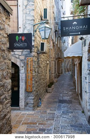 Narrow Street In Budva In Morning. Budva Among Oldest Urban Settlements Of Adriatic Coast, Unesco Wo