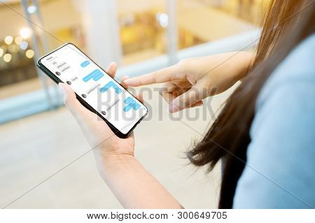 Woman Using Her Mobile Smartphone. She Chatting With Friend On Mobile Phone