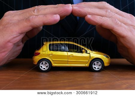 Insurance Agent  Is Protecting Car. Concept Of Auto Insurance.