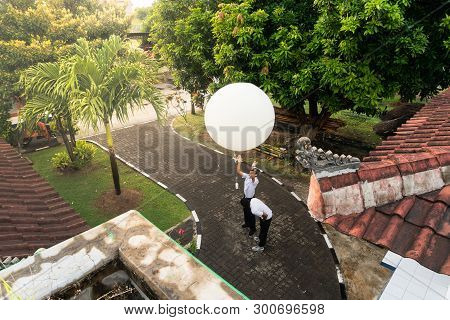 Badung/bali-april 10 2019: An Observer At Ngurah Rai Meteorological Station Releasing The Big White 